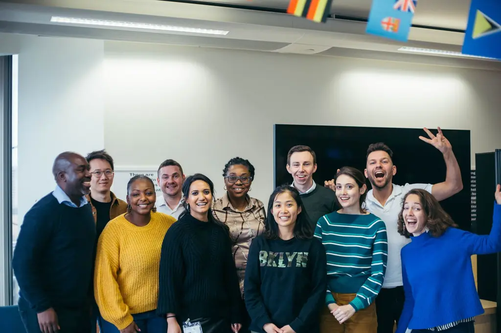 A smiling Talentrade cohort gathers for a group photo in a bright office
